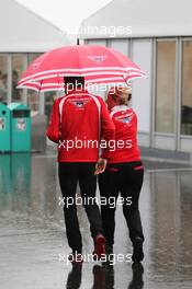 Jules Bianchi (FRA) Marussia F1 Team and Tracy Novak (GBR) Marussia F1 Team PR & Communications Director in a wet and rainy paddock. 02.10.2014. Formula 1 World Championship, Rd 15, Japanese Grand Prix, Suzuka, Japan, Preparation Day.