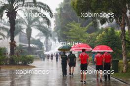 (L to R): Jules Bianchi (FRA) Marussia F1 Team and Max Chilton (GBR) Marussia F1 Team in a wet and rainy paddock. 28.03.2014. Formula 1 World Championship, Rd 2, Malaysian Grand Prix, Sepang, Malaysia, Friday.
