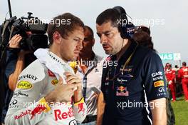 (L to R): Sebastian Vettel (GER) Red Bull Racing with Guillaume Rocquelin (ITA) Red Bull Racing Race Engineer on the grid. 30.03.2014. Formula 1 World Championship, Rd 2, Malaysian Grand Prix, Sepang, Malaysia, Sunday.