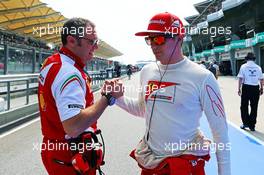 (L to R): Stefano Domenicali (ITA) Ferrari General Director with Kimi Raikkonen (FIN) Ferrari on the grid. 30.03.2014. Formula 1 World Championship, Rd 2, Malaysian Grand Prix, Sepang, Malaysia, Sunday.