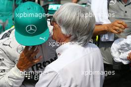 (L to R): Lewis Hamilton (GBR) Mercedes AMG F1 with Bernie Ecclestone (GBR) on the grid. 30.03.2014. Formula 1 World Championship, Rd 2, Malaysian Grand Prix, Sepang, Malaysia, Sunday.