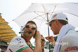 Nico Hulkenberg (GER) Sahara Force India F1 with Bradley Joyce (GBR) Sahara Force India F1 Race Engineer on the grid. 30.03.2014. Formula 1 World Championship, Rd 2, Malaysian Grand Prix, Sepang, Malaysia, Sunday.