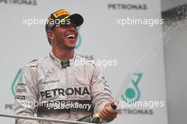 Race winner Lewis Hamilton (GBR) Mercedes AMG F1 celebrates with the champagne on the podium. 30.03.2014. Formula 1 World Championship, Rd 2, Malaysian Grand Prix, Sepang, Malaysia, Sunday.