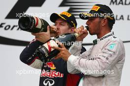 Sebastian Vettel (GER) Red Bull Racing and Lewis Hamilton (GBR) Mercedes AMG F1. 30.03.2014. Formula 1 World Championship, Rd 2, Malaysian Grand Prix, Sepang, Malaysia, Sunday.