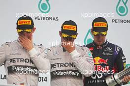 The podium (L to R): Nico Rosberg (GER) Mercedes AMG F1, second; Lewis Hamilton (GBR) Mercedes AMG F1, race winner; Sebastian Vettel (GER) Red Bull Racing, third. 30.03.2014. Formula 1 World Championship, Rd 2, Malaysian Grand Prix, Sepang, Malaysia, Sunday.