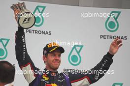 Sebastian Vettel (GER) Red Bull Racing celebrates his third position on the podium. 30.03.2014. Formula 1 World Championship, Rd 2, Malaysian Grand Prix, Sepang, Malaysia, Sunday.