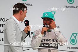 (L to R): Benedict Cumberbatch (GBR) Actor interviews race winner Lewis Hamilton (GBR) Mercedes AMG F1 on the podium. 30.03.2014. Formula 1 World Championship, Rd 2, Malaysian Grand Prix, Sepang, Malaysia, Sunday.