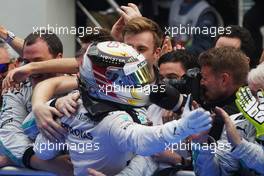 Race winner Lewis Hamilton (GBR) Mercedes AMG F1 celebrates with the team in parc ferme. 30.03.2014. Formula 1 World Championship, Rd 2, Malaysian Grand Prix, Sepang, Malaysia, Sunday.