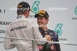 (L to R): Second placed Nico Rosberg (GER) Mercedes AMG F1 on the podium with third placed Sebastian Vettel (GER) Red Bull Racing. 30.03.2014. Formula 1 World Championship, Rd 2, Malaysian Grand Prix, Sepang, Malaysia, Sunday.