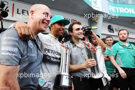 Race winner Lewis Hamilton (GBR) Mercedes AMG F1 celebrates with the team. 30.03.2014. Formula 1 World Championship, Rd 2, Malaysian Grand Prix, Sepang, Malaysia, Sunday.