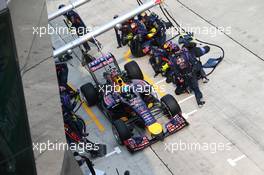 Sebastian Vettel (GER) Red Bull Racing RB10 pit stop. 30.03.2014. Formula 1 World Championship, Rd 2, Malaysian Grand Prix, Sepang, Malaysia, Sunday.