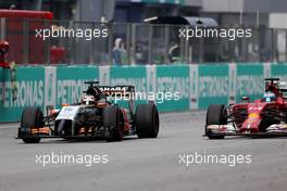 Nico Hulkenberg (GER), Sahara Force India and Fernando Alonso (ESP), Scuderia Ferrari  30.03.2014. Formula 1 World Championship, Rd 2, Malaysian Grand Prix, Sepang, Malaysia, Sunday.