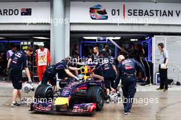 Sebastian Vettel (GER) Red Bull Racing RB10 in the pits. 29.03.2014. Formula 1 World Championship, Rd 2, Malaysian Grand Prix, Sepang, Malaysia, Saturday.