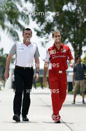 (L to R): Eric Boullier (FRA) McLaren Racing Director with Renato Bisignani (ITA) Ferrari Head of Communications. 30.03.2014. Formula 1 World Championship, Rd 2, Malaysian Grand Prix, Sepang, Malaysia, Sunday.