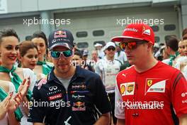 (L to R): Sebastian Vettel (GER) Red Bull Racing and Kimi Raikkonen (FIN) Ferrari on the drivers parade. 30.03.2014. Formula 1 World Championship, Rd 2, Malaysian Grand Prix, Sepang, Malaysia, Sunday.