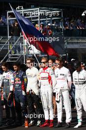 The drivers take a moment in respect of Jules Bianchi (FRA) Marussia F1 Team MR03. 12.10.2014. Formula 1 World Championship, Rd 16, Russian Grand Prix, Sochi Autodrom, Sochi, Russia, Race Day.