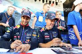 (L to R): Daniel Ricciardo (AUS) Red Bull Racing and team mate Sebastian Vettel (GER) Red Bull Racing sign autographs for the fans at the Fanzone. 09.10.2014. Formula 1 World Championship, Rd 16, Russian Grand Prix, Sochi Autodrom, Sochi, Russia, Preparation Day.