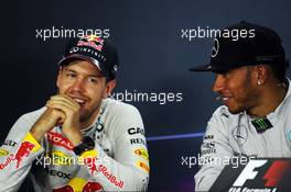 (L to R): Sebastian Vettel (GER) Red Bull Racing and Lewis Hamilton (GBR) Mercedes AMG F1 in the FIA Press Conference. 21.09.2014. Formula 1 World Championship, Rd 14, Singapore Grand Prix, Singapore, Singapore, Race Day.