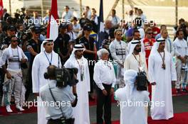 Bernie Ecclestone (GBR) and the drivers observe the anthem on the grid. 23.11.2014. Formula 1 World Championship, Rd 19, Abu Dhabi Grand Prix, Yas Marina Circuit, Abu Dhabi, Race Day.