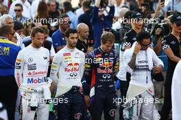 (L to R): Jenson Button (GBR) McLaren; Daniel Ricciardo (AUS) Red Bull Racing; Sebastian Vettel (GER) Red Bull Racing; and Lewis Hamilton (GBR) Mercedes AMG F1 observe the anthem on the grid. 23.11.2014. Formula 1 World Championship, Rd 19, Abu Dhabi Grand Prix, Yas Marina Circuit, Abu Dhabi, Race Day.
