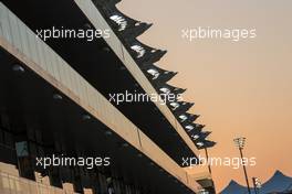 A paddok building at sunset. 20.11.2014. Formula 1 World Championship, Rd 19, Abu Dhabi Grand Prix, Yas Marina Circuit, Abu Dhabi, Preparation Day.