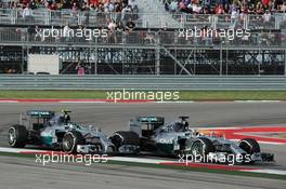 Lewis Hamilton (GBR) Mercedes AMG F1 W05 passes team mate Nico Rosberg (GER) Mercedes AMG F1 W05 to take the lead of the race. 02.11.2014. Formula 1 World Championship, Rd 17, United States Grand Prix, Austin, Texas, USA, Race Day.