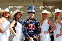 Sebastian Vettel (GER) Red Bull Racing with the grid girls. 02.11.2014. Formula 1 World Championship, Rd 17, United States Grand Prix, Austin, Texas, USA, Race Day.