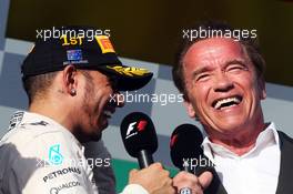 (L to R): Race winner Lewis Hamilton (GBR) Mercedes AMG F1 on the podium with Arnold Schwarzenegger (USA). 15.03.2015. Formula 1 World Championship, Rd 1, Australian Grand Prix, Albert Park, Melbourne, Australia, Race Day.