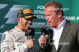 (L to R): race winner Lewis Hamilton (GBR) Mercedes AMG F1 on the podium with Arnold Schwarzenegger (USA). 15.03.2015. Formula 1 World Championship, Rd 1, Australian Grand Prix, Albert Park, Melbourne, Australia, Race Day.