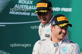 Race winner Lewis Hamilton (GBR) Mercedes AMG F1 celebrates on the podium with team mate Nico Rosberg (GER) Mercedes AMG F1. 15.03.2015. Formula 1 World Championship, Rd 1, Australian Grand Prix, Albert Park, Melbourne, Australia, Race Day.
