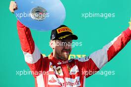 Sebastian Vettel (GER) Ferrari celebrates his third position on the podium. 15.03.2015. Formula 1 World Championship, Rd 1, Australian Grand Prix, Albert Park, Melbourne, Australia, Race Day.