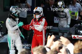 (L to R): Nico Rosberg (GER) Mercedes AMG F1 with Sebastian Vettel (GER) Ferrari in parc ferme. 15.03.2015. Formula 1 World Championship, Rd 1, Australian Grand Prix, Albert Park, Melbourne, Australia, Race Day.