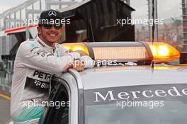 Pole sitter Lewis Hamilton (GBR) Mercedes AMG F1 celebrates in the FIA Medical Car. 14.03.2015. Formula 1 World Championship, Rd 1, Australian Grand Prix, Albert Park, Melbourne, Australia, Qualifying Day.