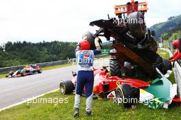 Marshals remove the start crash involving Fernando Alonso (ESP) McLaren MP4-30 and Kimi Raikkonen (FIN) Ferrari SF15-T. 21.06.2015. Formula 1 World Championship, Rd 8, Austrian Grand Prix, Spielberg, Austria, Race Day.