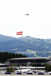 A helicopter with the Austrian flag. 21.06.2015. Formula 1 World Championship, Rd 8, Austrian Grand Prix, Spielberg, Austria, Race Day.