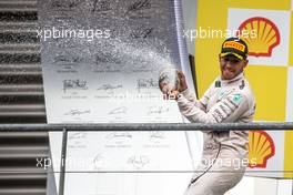 Race winner Lewis Hamilton (GBR) Mercedes AMG F1 celebrates with the champagne on the podium. 23.08.2015. Formula 1 World Championship, Rd 13, Belgian Grand Prix, Spa Francorchamps, Belgium, Race Day.