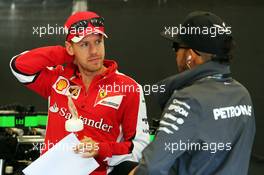 (L to R): Sebastian Vettel (GER) Ferrari with Lewis Hamilton (GBR) Mercedes AMG F1. 23.08.2015. Formula 1 World Championship, Rd 13, Belgian Grand Prix, Spa Francorchamps, Belgium, Race Day.
