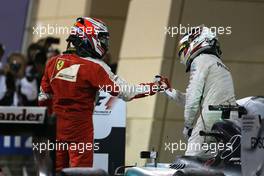Kimi Raikkonen (FIN), Scuderia Ferrari and Lewis Hamilton (GBR), Mercedes AMG F1 Team  19.04.2015. Formula 1 World Championship, Rd 4, Bahrain Grand Prix, Sakhir, Bahrain, Race Day.