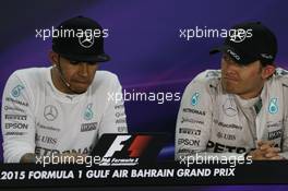 (L to R): Lewis Hamilton (GBR) Mercedes AMG F1 with team mate Nico Rosberg (GER) Mercedes AMG F1 in the FIA Press Conference. 19.04.2015. Formula 1 World Championship, Rd 4, Bahrain Grand Prix, Sakhir, Bahrain, Race Day.