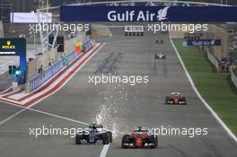 Nico Rosberg (GER) Mercedes AMG F1 W06 and Sebastian Vettel (GER) Ferrari SF15-T battle for position. 19.04.2015. Formula 1 World Championship, Rd 4, Bahrain Grand Prix, Sakhir, Bahrain, Race Day.