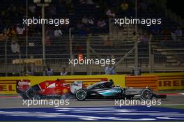 Lewis Hamilton (GBR) Mercedes AMG F1 W06 and Kimi Raikkonen (FIN) Ferrari SF15-T battle for position. 19.04.2015. Formula 1 World Championship, Rd 4, Bahrain Grand Prix, Sakhir, Bahrain, Race Day.