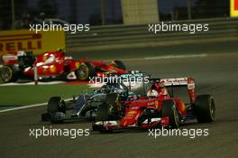 Sebastian Vettel (GER) Ferrari SF15-T leads Nico Rosberg (GER) Mercedes AMG F1 W06. 19.04.2015. Formula 1 World Championship, Rd 4, Bahrain Grand Prix, Sakhir, Bahrain, Race Day.