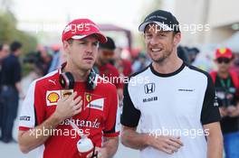 (L to R): Sebastian Vettel (GER) Ferrari with Jenson Button (GBR) McLaren. 19.04.2015. Formula 1 World Championship, Rd 4, Bahrain Grand Prix, Sakhir, Bahrain, Race Day.