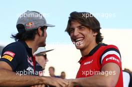 (L to R): Carlos Sainz Jr (ESP) Scuderia Toro Rosso with Roberto Merhi (ESP) Manor Marussia F1 Team on the drivers parade. 19.04.2015. Formula 1 World Championship, Rd 4, Bahrain Grand Prix, Sakhir, Bahrain, Race Day.