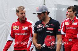 (L to R): Sebastian Vettel (GER) Ferrari with Carlos Sainz Jr (ESP) Scuderia Toro Rosso. 05.06.2015. Formula 1 World Championship, Rd 7, Canadian Grand Prix, Montreal, Canada, Practice Day.