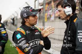 Sergio Perez (MEX) Sahara Force India F1 with Tim Wright (GBR) Sahara Force India F1 Team Race Engineer on the grid. 12.04.2015. Formula 1 World Championship, Rd 3, Chinese Grand Prix, Shanghai, China, Race Day.