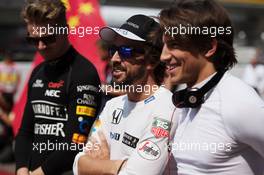 (L to R): Fernando Alonso (ESP) McLaren with Roberto Merhi (ESP) Manor Marussia F1 Team on the grid. 12.04.2015. Formula 1 World Championship, Rd 3, Chinese Grand Prix, Shanghai, China, Race Day.