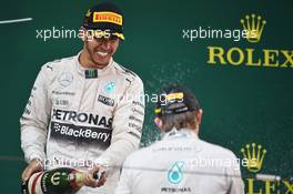 Race winner Lewis Hamilton (GBR) Mercedes AMG F1 celebrates with the champagne on the podium with second placed team mate Nico Rosberg (GER) Mercedes AMG F1. 12.04.2015. Formula 1 World Championship, Rd 3, Chinese Grand Prix, Shanghai, China, Race Day.