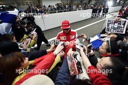 Kimi Raikkonen (FIN) Ferrari signs autographs for the fans. 09.04.2015. Formula 1 World Championship, Rd 3, Chinese Grand Prix, Shanghai, China, Preparation Day.