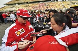 Kimi Raikkonen (FIN) Ferrari signs autographs for the fans. 09.04.2015. Formula 1 World Championship, Rd 3, Chinese Grand Prix, Shanghai, China, Preparation Day.